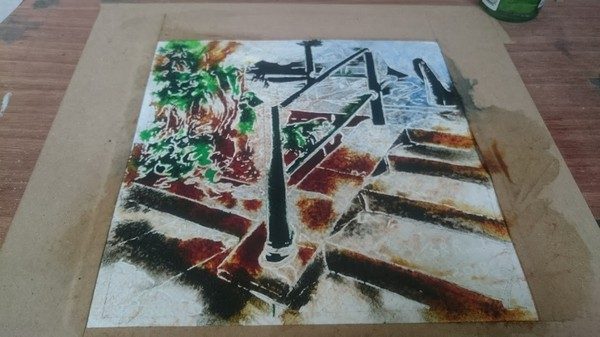 Painting in progress of a handrail and steps.