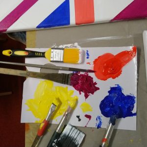 Paints on palette, brushes, canvas